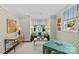 Bright sitting room featuring a comfortable couch, desk and playful wallpaper at 206 Hillside Ave, Charlotte, NC 28209