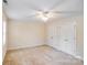 Bright bedroom with neutral carpet, ceiling fan, and double door closet at 2065 Gable Way Ln, Matthews, NC 28104