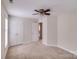 Bedroom with neutral carpet, ceiling fan, double door closet and a doorway at 2065 Gable Way Ln, Matthews, NC 28104