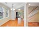 Inviting dining room with hardwood floors, a chandelier, and a staircase leading to the upper level at 2065 Gable Way Ln, Matthews, NC 28104