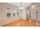 Bright dining room with hardwood floors, chandelier and ample natural light from large windows at 2065 Gable Way Ln, Matthews, NC 28104