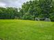 Expansive green sports field surrounded by lush trees, including soccer goals and a gazebo at 2065 Gable Way Ln, Matthews, NC 28104
