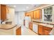 Bright kitchen featuring light wood cabinets, white appliances, and a view of the backyard at 2065 Gable Way Ln, Matthews, NC 28104