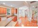 Open concept kitchen featuring wooden cabinets, breakfast bar, and hardwood floors at 2065 Gable Way Ln, Matthews, NC 28104