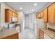Functional kitchen featuring light wood cabinets and white appliances, providing a clean, classic look at 2065 Gable Way Ln, Matthews, NC 28104