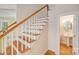 Classic staircase with wooden rails and white spindles, leading to an upper level near the bathroom at 2065 Gable Way Ln, Matthews, NC 28104