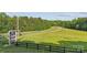Scenic entrance to Royal Gold Mine, featuring lush greenery, signage, and a black fence at 21047 Running Creek Dr # 9, Locust, NC 28097