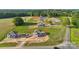 Aerial view of multiple new homes under construction, surrounded by grassy landscapes and roadways at 21055 Running Creek Dr # 10, Locust, NC 28097
