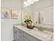 Stylish bathroom featuring double vanity with granite countertops, framed art, and large mirror at 21055 Running Creek Dr # 10, Locust, NC 28097