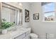 Bright bathroom features a granite countertop, vanity, framed mirror, and decorative artwork at 21055 Running Creek Dr # 10, Locust, NC 28097