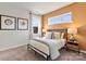 Comfortable bedroom with natural light, neutral carpet, decorative wall art, and warm accent wall at 21055 Running Creek Dr # 10, Locust, NC 28097