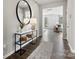 Stylish entryway features a modern console table, round mirror, and a view into the living area at 21055 Running Creek Dr # 10, Locust, NC 28097