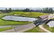 Picturesque golf course view featuring a covered bridge next to a pond and manicured green landscape at 21055 Running Creek Dr # 10, Locust, NC 28097