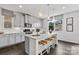 Modern kitchen island featuring granite countertops, pendant lighting, and bar stool seating at 21055 Running Creek Dr # 10, Locust, NC 28097