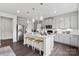 Contemporary kitchen boasts granite countertops, stainless steel appliances, and stylish pendant lights at 21055 Running Creek Dr # 10, Locust, NC 28097