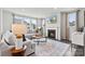 Inviting living room with a fireplace, large sofa, and plenty of natural light from expansive windows at 21055 Running Creek Dr # 10, Locust, NC 28097