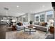 Open-concept living space with a large sofa, modern decor, and seamless access to the kitchen area at 21055 Running Creek Dr # 10, Locust, NC 28097