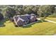 Expansive aerial view of a brick home with lush green lawn and tree lined perimeter at 214 Silver Creek Ln, Shelby, NC 28152