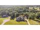 Aerial view of the property featuring a well-maintained lawn, a detached garage, and a private treed backyard at 214 Silver Creek Ln, Shelby, NC 28152