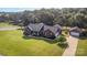 Wide aerial shot of the brick house, detached garage and surrounding lush landscape at 214 Silver Creek Ln, Shelby, NC 28152