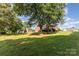 Picturesque backyard with mature trees surrounding the brick home at 214 Silver Creek Ln, Shelby, NC 28152
