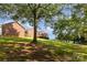 Lush backyard featuring beautiful trees and views of the home's deck, creating a serene outdoor space at 214 Silver Creek Ln, Shelby, NC 28152