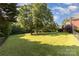 Manicured lawn with shade trees along a fence line at 214 Silver Creek Ln, Shelby, NC 28152