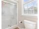Bathroom featuring a walk-in shower with glass door and toilet at 214 Silver Creek Ln, Shelby, NC 28152