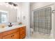 Bathroom featuring a vanity with cabinet and mirror, a walk-in shower at 214 Silver Creek Ln, Shelby, NC 28152