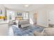 Bright bedroom with shuttered windows, a metal bed frame, and a comfortable sitting area at 214 Silver Creek Ln, Shelby, NC 28152