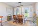 Bright dining room featuring a rustic wooden table, shuttered windows and a stylish light fixture at 214 Silver Creek Ln, Shelby, NC 28152