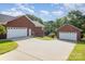 Long driveway leading to brick home with multiple garage doors at 214 Silver Creek Ln, Shelby, NC 28152
