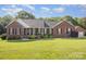 Traditional brick home with a well-manicured lawn, updated roof, and a detached two car garage at 214 Silver Creek Ln, Shelby, NC 28152