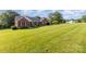 A beautiful ranch style home with well-maintained lawn and a tree in the yard at 214 Silver Creek Ln, Shelby, NC 28152