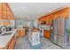 Bright kitchen featuring wood cabinets, stainless appliances, tile backsplash and center island at 214 Silver Creek Ln, Shelby, NC 28152