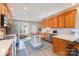 Spacious kitchen features wood cabinetry, stainless appliances and a center island with seating at 214 Silver Creek Ln, Shelby, NC 28152