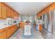 Open kitchen with wood cabinets, stainless steel appliances, center island and adjacent dining area at 214 Silver Creek Ln, Shelby, NC 28152