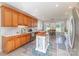 Open kitchen with wood cabinets, stainless steel appliances, center island and adjacent dining area at 214 Silver Creek Ln, Shelby, NC 28152