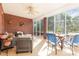 Relaxing screened porch featuring brick wall, ceiling fan, and comfortable seating at 214 Silver Creek Ln, Shelby, NC 28152
