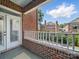Brick balcony featuring brick construction overlooking neighboring homes and lush landscaping at 2315 Selwyn Ave # F, Charlotte, NC 28207