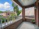 Brick balcony overlooks residential neighborhood with mature trees and lush landscaping at 2315 Selwyn Ave # F, Charlotte, NC 28207