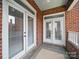 Brick balcony featuring brick construction and double doors that provide access to the interior at 2315 Selwyn Ave # F, Charlotte, NC 28207