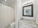Bright bathroom features marble vanity, shower with white curtain, and mosaic tiled floor at 2315 Selwyn Ave # F, Charlotte, NC 28207