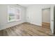 Bedroom featuring neutral walls, hardwood floors, closet and a bright sunny window with blinds at 2315 Selwyn Ave # F, Charlotte, NC 28207