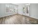Bright, empty bedroom with large windows, white trim, and modern flooring at 2315 Selwyn Ave # F, Charlotte, NC 28207