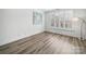 Bright, empty bedroom featuring large windows, light walls, and contemporary flooring at 2315 Selwyn Ave # F, Charlotte, NC 28207