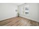 Bedroom featuring neutral walls, hardwood floors, and a bright sunny window with blinds at 2315 Selwyn Ave # F, Charlotte, NC 28207