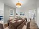 Elegant dining room featuring a wooden table, neutral chairs, and stylish modern light fixture at 2315 Selwyn Ave # F, Charlotte, NC 28207