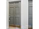 Close-up of a gray apartment door with a lock and white trim at 2315 Selwyn Ave # F, Charlotte, NC 28207