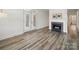 Open living area with a fireplace, wood floors, and French doors, offering a bright and airy space at 2315 Selwyn Ave # F, Charlotte, NC 28207
